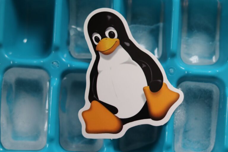 CVE Breakdown: Critical Linux Kernel Vulnerabilities in 2026 Close-up of a Linux penguin sticker placed on a blue ice cube tray with frozen cubes.