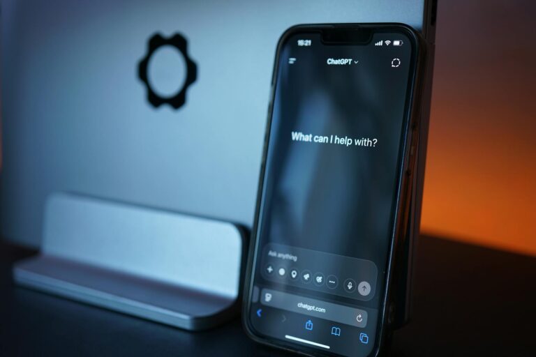 How to Build an AI Chatbot for IT Helpdesk Close-up of a smartphone with AI chat interface, showcasing advanced technology in a sleek design.