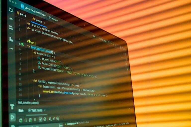 AWS vs Azure vs GCP: Which Cloud is Best for IT Pros Blurry close-up of a computer screen displaying code with orange lighting.