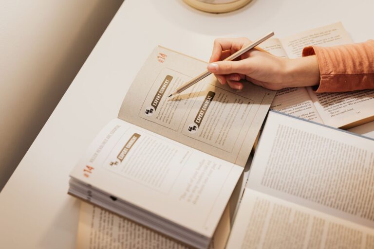 CompTIA Security+ Study Guide 2026 A woman using a pencil to annotate books while studying at a desk.